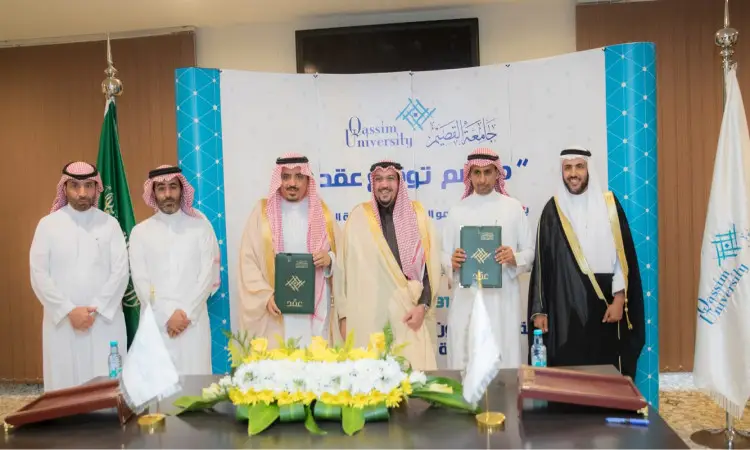 Six men shed their traditional Saudi attire, including the Ghutrah, Shemaghat, Eqal and Bashtet, to take on the image of Saudi Arabia, to connect with children, in a signing ceremony at Qassim University, in front of a banner and a table with flowers and official documents, signaling a new construction of the mental brain.