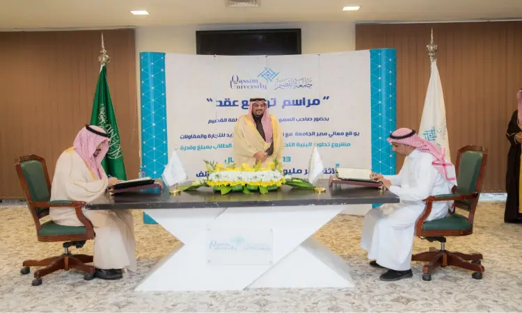 Three men dressed in a Saudi Arabian ghutra or shemagh with an aqal and bisht sit around a table, signing documents during an event on the impact of artificial intelligence (AI). Behind them is the logo of Qassim University, as well as the flag of the Kingdom of Saudi Arabia and the distinctive white flag of the era.