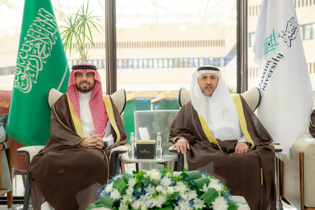 Two men dressed in the official Saudi uniform of a ghattar or shamaghqal, a Saudi besht, and, in a variation of neutrality, nursing staff during the men's visit to the University of Qassim (UQ). For everything from the Saudi Arabian flag and the university's flag, to the center of the table decorated with flowers and bottles of the bright water gate.