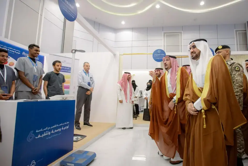 زار من الرجال مرتدين الغترة أو الشماغ السعودي مع العقال والبشت السعودي، يتقدمهم صاحب السمو أمير منطقة القصيم، جناح معرض حملة الجامعة الشاملة. وقد تجول الحديث بين الأركان المختلفة، بمختلف مع الموظفين بزيهم الرسمي وسط لوحات إرشادية وصحية ومنصات توعوية داخلية تبرز جهود جامعة القصيم في التوعية المجتمعية.