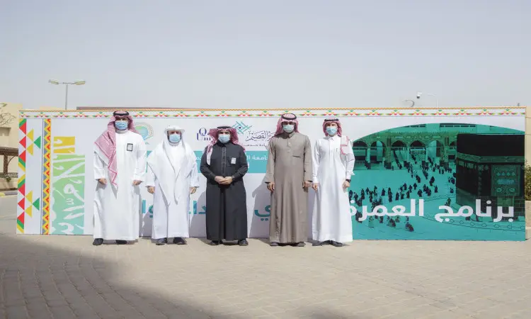 Each of the five men, dressed in the Saudi ghagha or shemagh with aqal and Saudi bisht, wearing masks, posed in front of a sign bearing the image of the Mushrifa, Arabic texts and the logo of Qassim University. The outdoor event seemed to be related to the Umrah program for martyred participants on a sunny day.