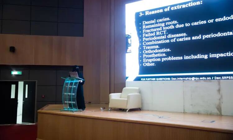 أتشخص مرتدياً عباءة سوداء ونقاباً، وقد اعتمر شماغاً سعودياً مع عقال، وارتدى بشتاً سعودياً رسمياً الطابعة، خلف المنصّة في قاعة المحاضرات في القاسم. يوضّح بشكل واضح حول سبب خلع الأسنان في مجال طب الأسنان، حيث يوجد موضوعات مثل التسوس والوسادة التقويمية للأسنان. تغيير حجم الكراسي المتحركة بقياسات بيضاء للتنظيم الرسمي للمناسبة.