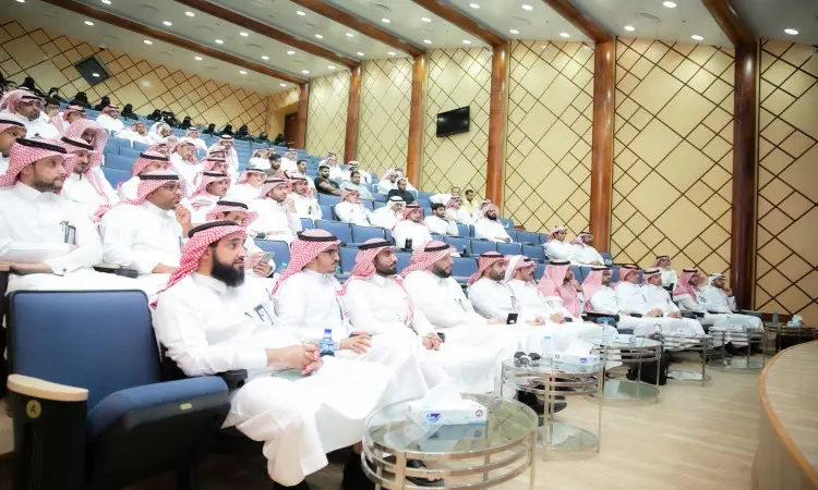 A group of men dressed in Saudi Arabia's Ghutra or Shemagh, Eqal and Bisht, attended a workshop in a modern lecture hall in Qassim to discuss energy conservation. Elegant wooden podiums and glass tables were sought after, reflecting the full range of governmental bodies on the subject.