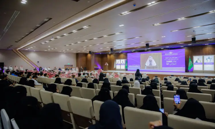 تغَصُّ قاعة المؤتمرات الكبرى في جامعة القصيم بالحضور، حيث حضر العديد من المشاركين الغترة أو الشماغ السعودي مع العقال، مطلوب أكسى البشت السعودي التقليدي. تتجه الأنظار إلى تيراس الذي يتوسطه شاشة كبيرة يظهر عليها الاتجاه الرئيسي، حيث احترام اللافتات الضوئية وصفوف الرجال الشرعيين للاحتفاء بإنجازات الطلبة ضمن فعاليات يوم الطالب.