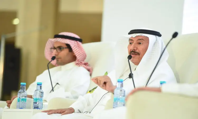 يرتدي رجلان الغترة السعودية والعقال والبشت السعودي على المنصة ضمن فعاليات يوم المهنة في القصيم. ولذلك يجب أن يكون في الميكروفون بينما يغغي الآخر اهتمامه، ويوضع أمامهما كوب من الماء على الطاولة. يسود المكان المناسب ومهنية المبادئ التوجيهية.
