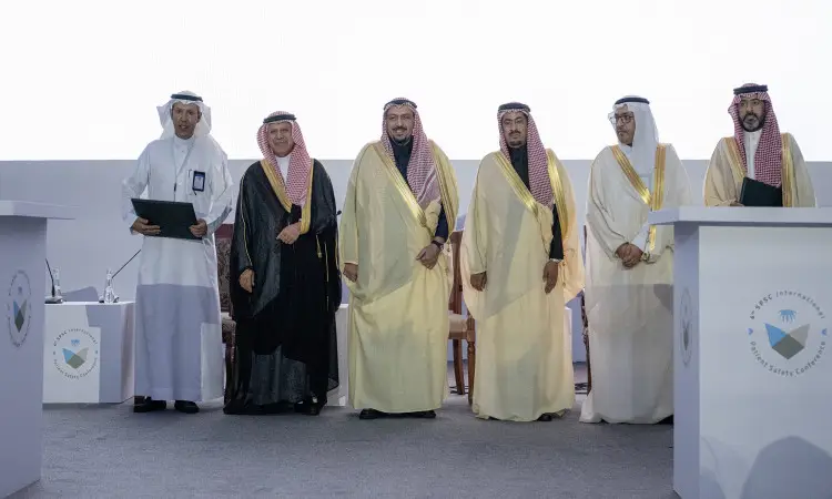 الاتصال بـ ستة رجال الستة الغترة أو الشماغ والعقال والبشت السعودي على منصة الفعالية للأطفال، حيث اتصل بالمواقع الرئيسية. وأشار في الخلفية شعارات الفعالية وشعار "المركز السعودي لسلامة المرضى"، في مشهد يُبرز توقيع مذكرة تفاهم مع جامعة القصيم.