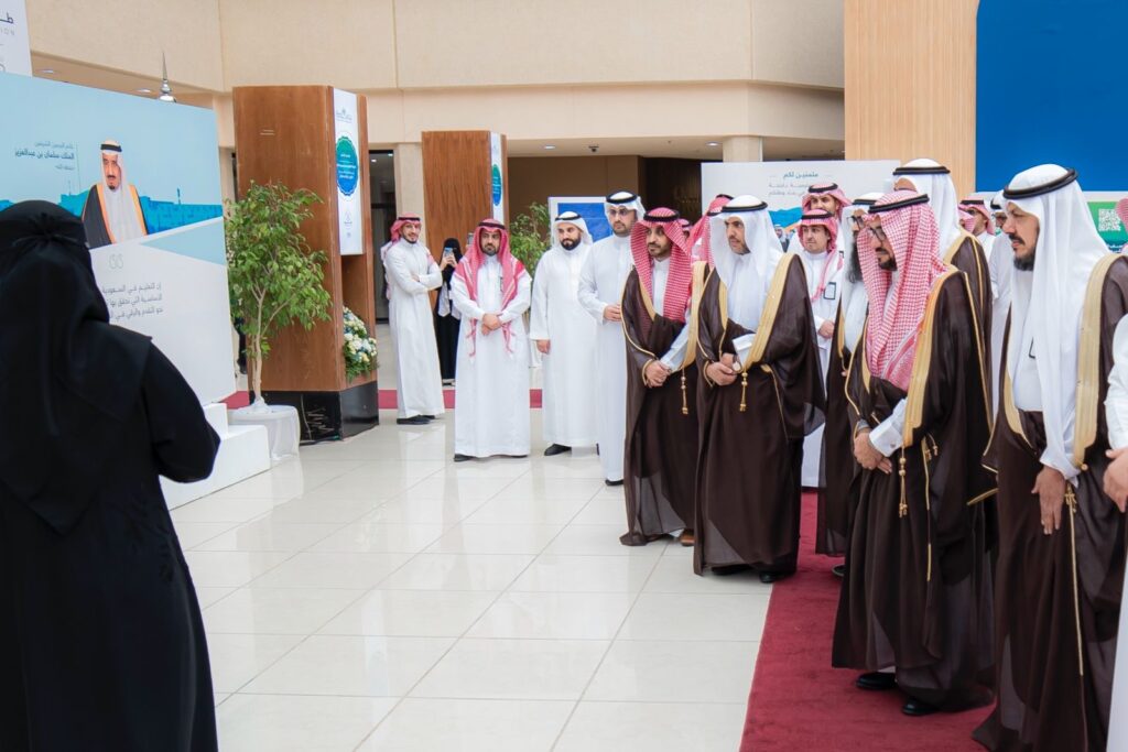 An academic ceremony for the Qassim Ambition program with official documentation of the event in the auditorium.