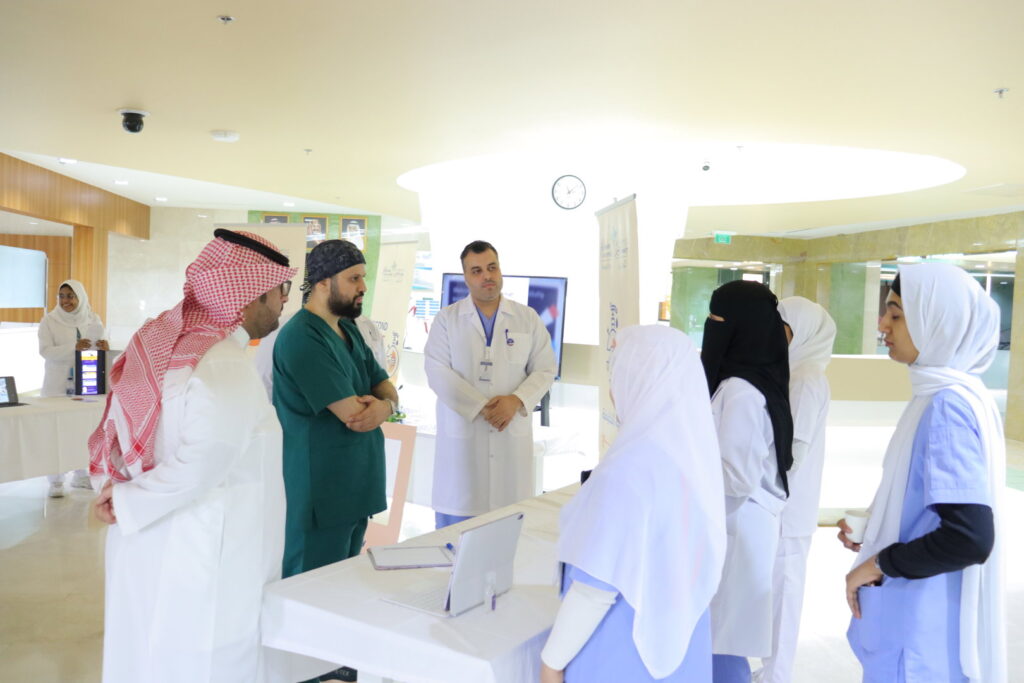 An academic discussion for a Saudi health team at Qassim University on strengthening health awareness programs.