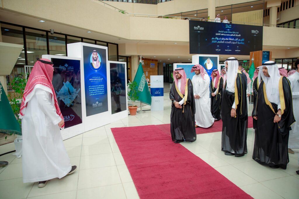 Qassim University's academic event at the Worlds Fair exhibition, with an official presence and Saudi flags.