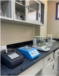 Laboratory equipment for analyzing the water network at Qassim University, including weighing and pollution prevention devices.