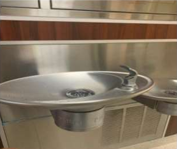 A metal drinking fountain at Qassim University emphasizes water care and hospitality in the Saudi Muslim community.