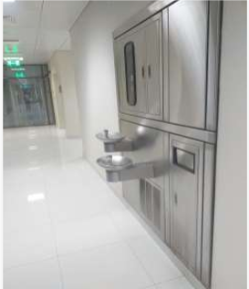 Free bottled drinking water in a university corridor at Qassim University to serve students and visitors.