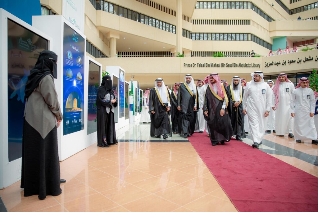 World Space Week event at Qassim University with scientific presentations and office guidance in both languages.