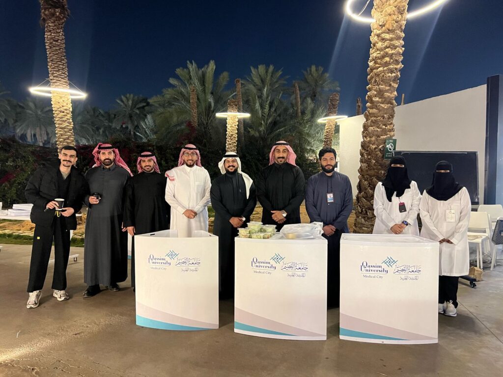 A health awareness event at Qassim University as part of community service activities in an evening atmosphere.