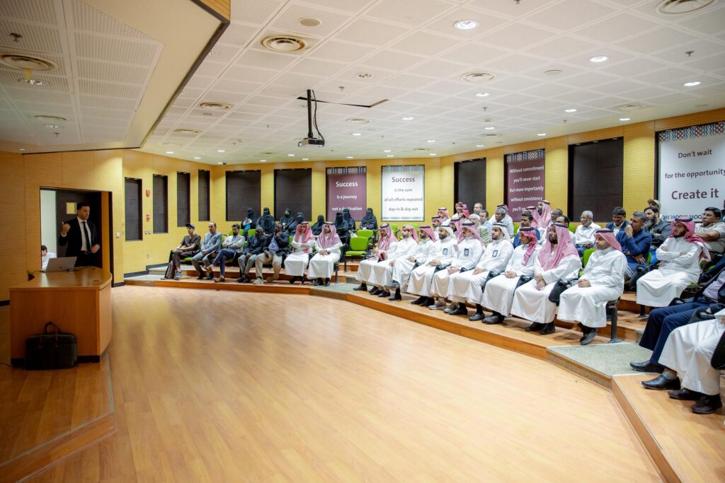 An academic audience at the Qassim University auditorium to listen to a lecture on global space.