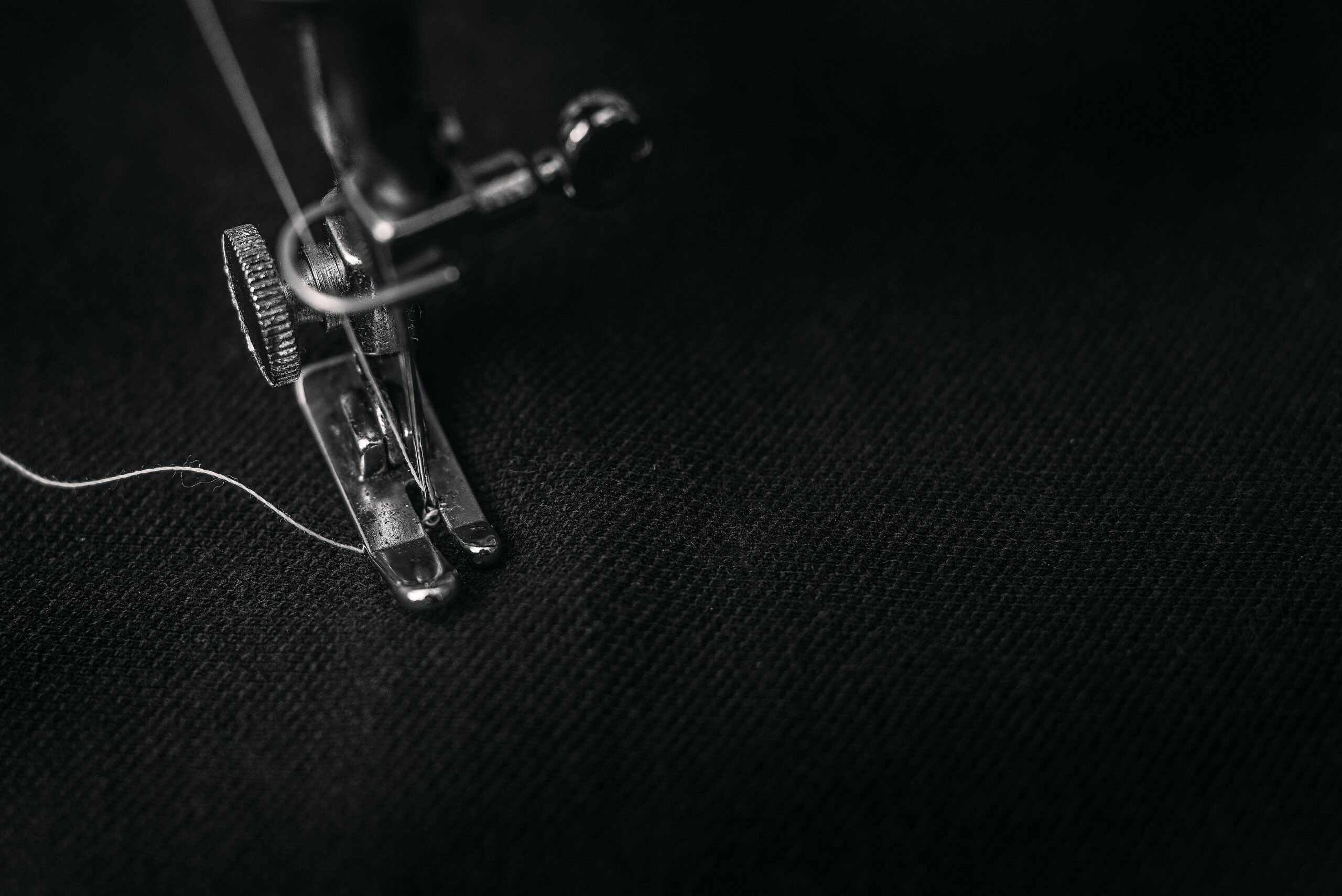 A detailed view of a sewing machine needle demonstrating the accuracy of the technical work in the Qassim University lab.