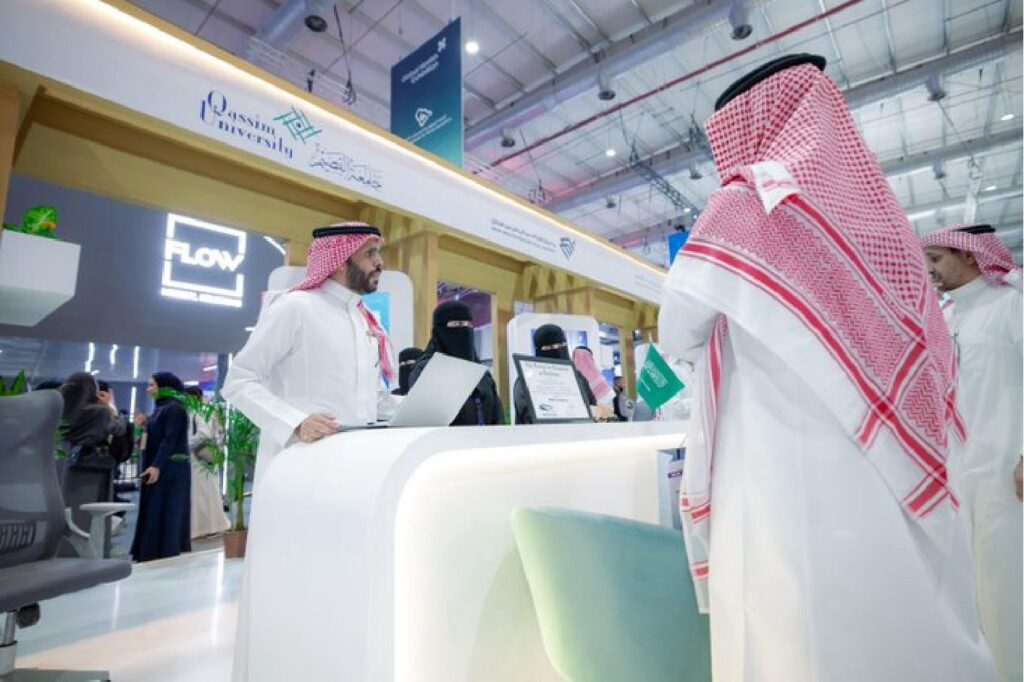 Qassim University's interactive pavilion at an academic exhibition highlighting Saudi digital and hydraulic services.
