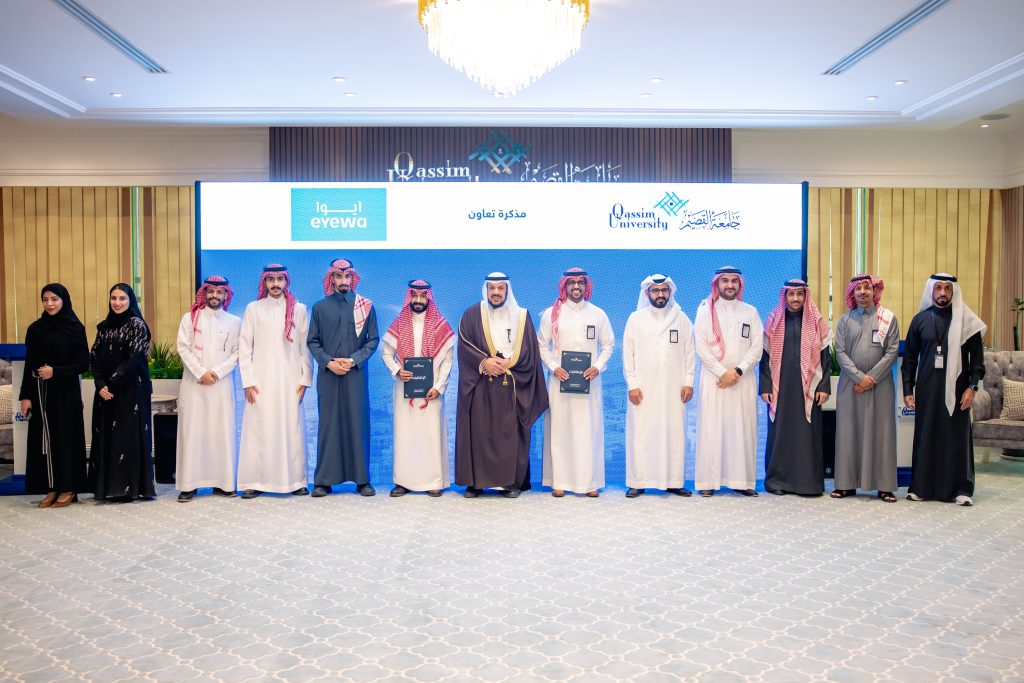 An academic honor for a group of Qassim University affiliates in the presence of Iowa and university logos.