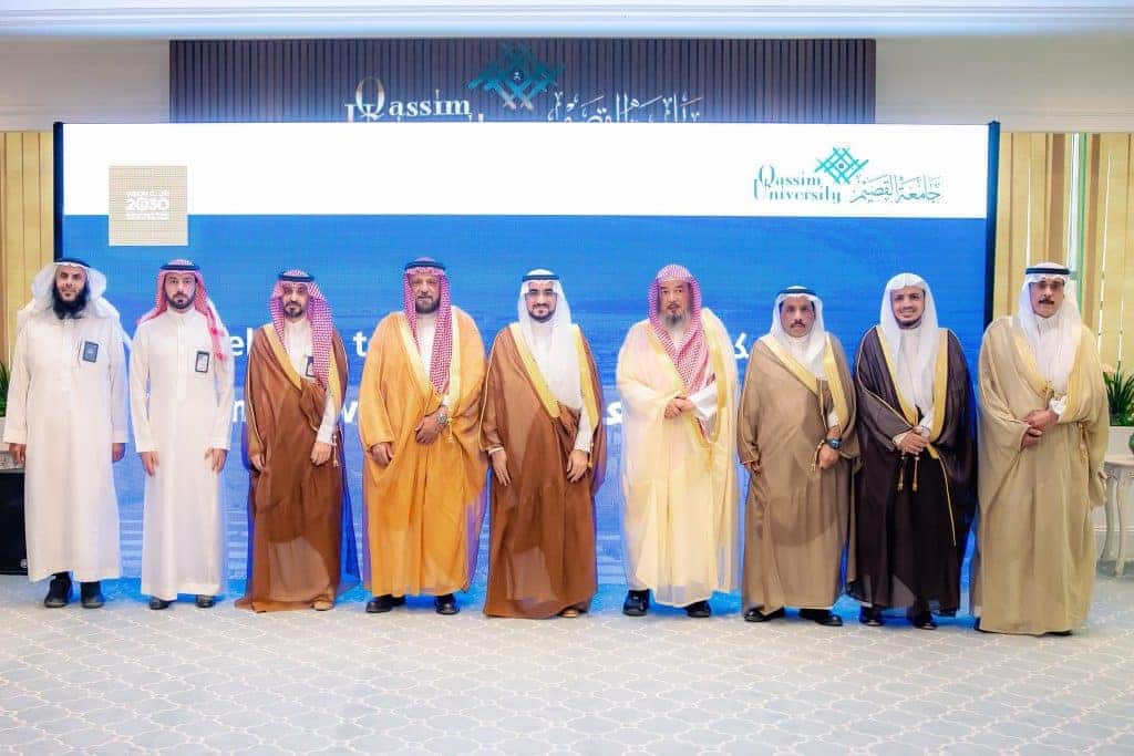 صورة توثق شراكة مجتمعية لرئيس جامعة القصيم مع وفد في أكاديمية أكاديمية رسمية.