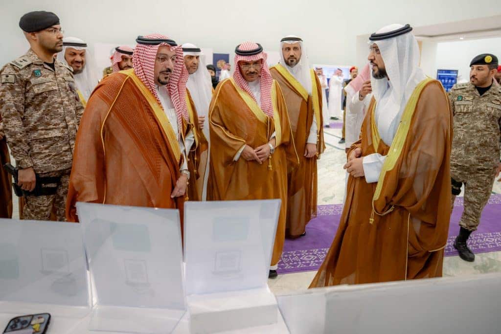 An academic discusses the latest technologies at the National Exhibition at Qassim University.