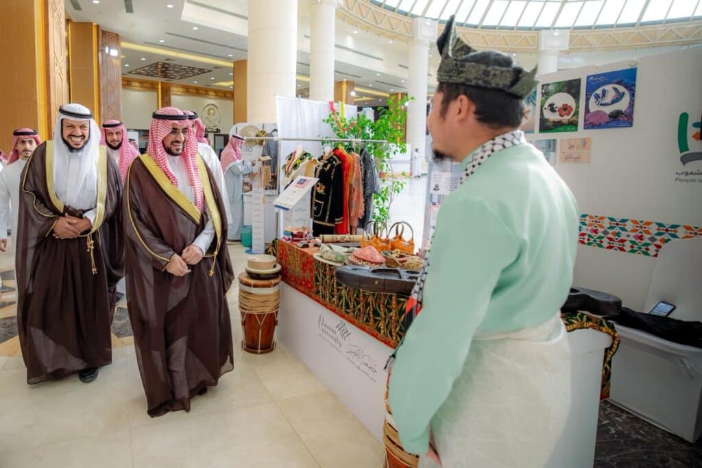 مشاركون يتفاعلون في مهرجان تراث الشعوب بجامعة القصيم احتفاءً بالتنوع الثقافي.