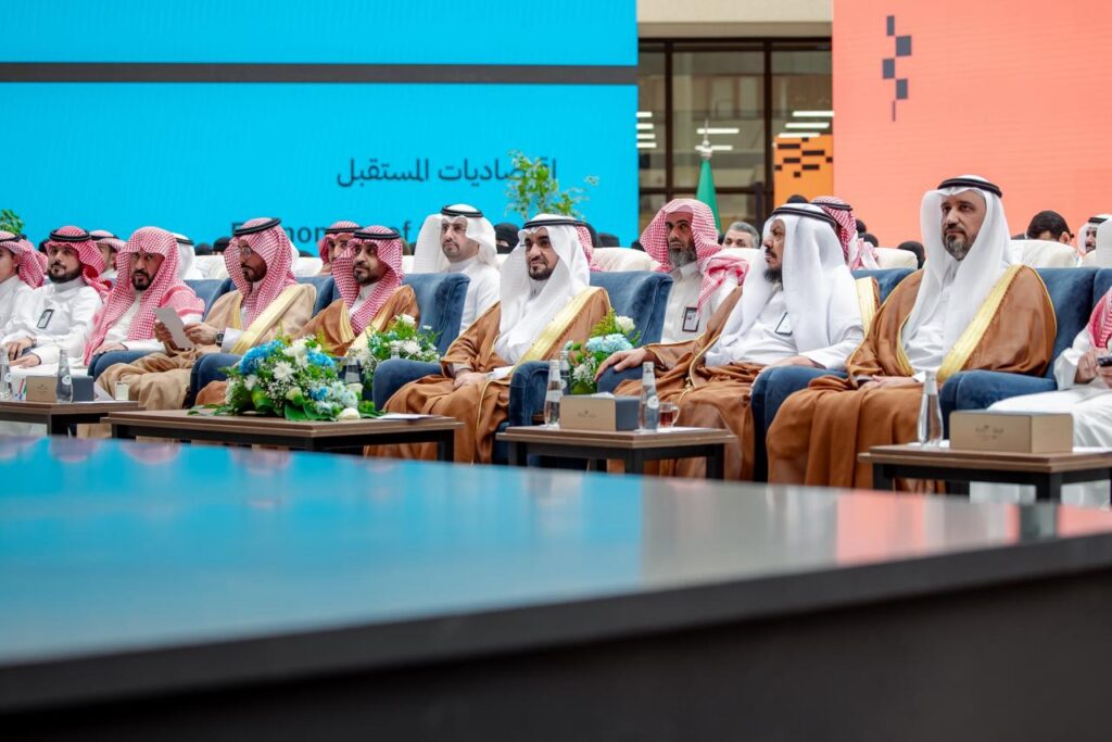 Academic presence at an official event at Qassim University with two presentations of Arabic content.