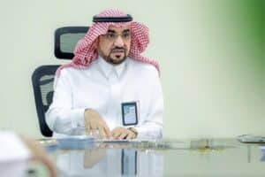 The President of Qassim University chairs the Standing Committee meeting in a formal academic setting.