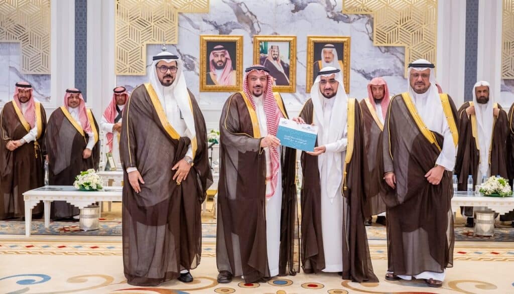 تكريم أكاديمي في جامعة القصيم بحضور قيادي، مع إبراز الطابع الرسمي والاعتزاز الوطني.