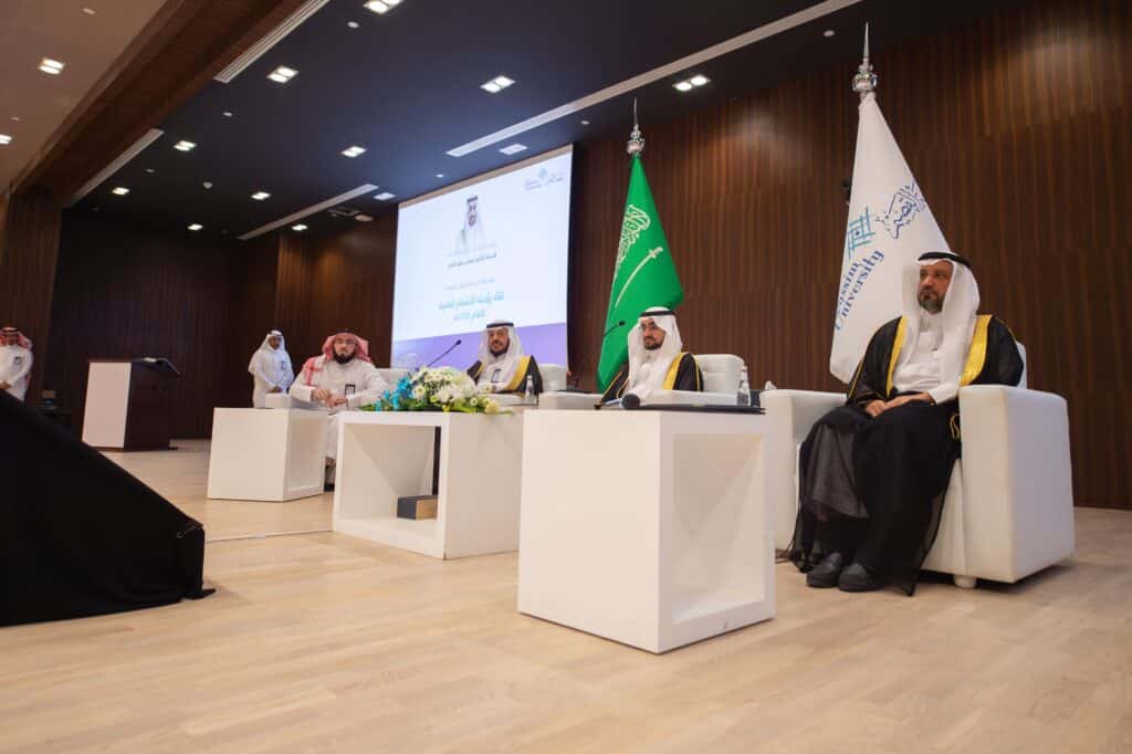 A formal meeting of department heads with the university president in the conference hall at Qassim University.