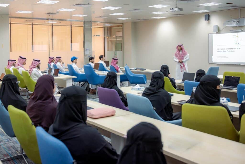 An academic meeting for Qassim University staff in a lecture hall to follow up on a scientific presentation.