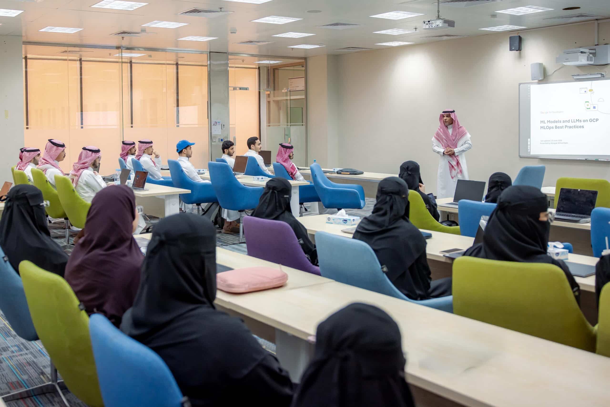 An academic meeting for Qassim University staff in a lecture hall to follow up on a scientific presentation.