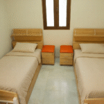 A quiet double student dorm room in one of Qassim University's student housing buildings.