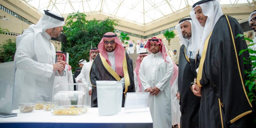 Students view documents and exhibits at the Worlds exhibit at Qassim University during Space Week.