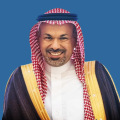 A representative of the Partnership Committee at Qassim University during an academic event, reflecting community values.