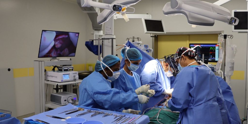 Performing a surgical procedure at Qassim University Hospital using advanced medical techniques and meticulous documentation of the steps.