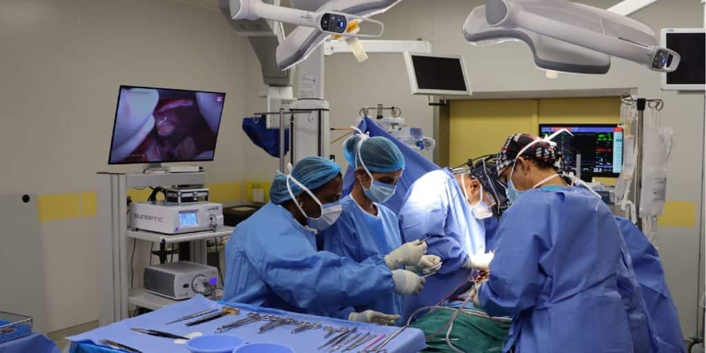 Performing a surgical procedure at Qassim University Hospital using advanced medical techniques and meticulous documentation of the steps.