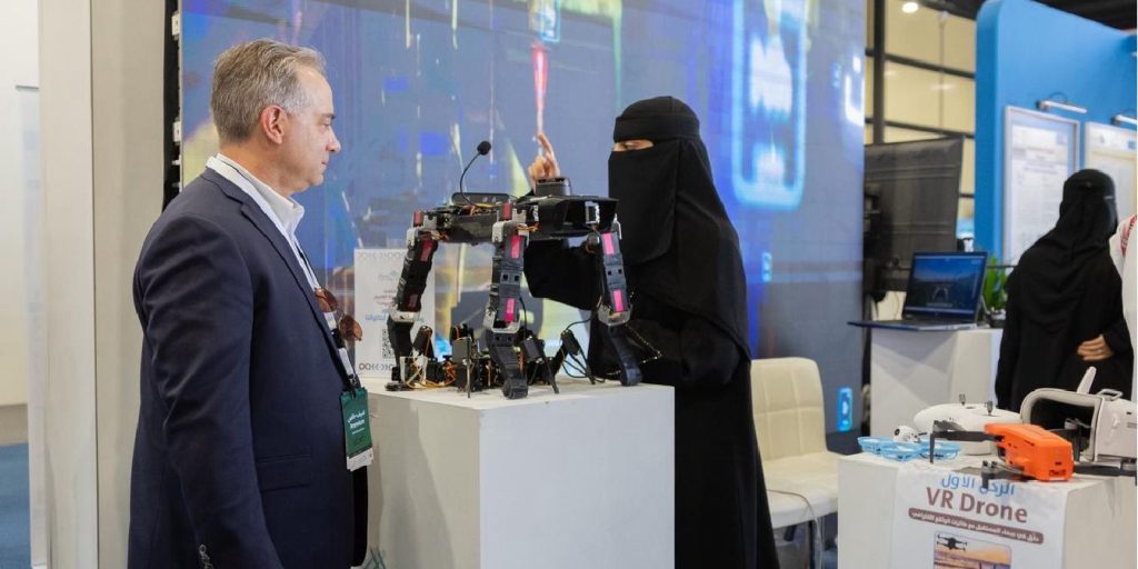 An academic discussion at the Qassim University pavilion at the Technology Exhibition to showcase drone projects.