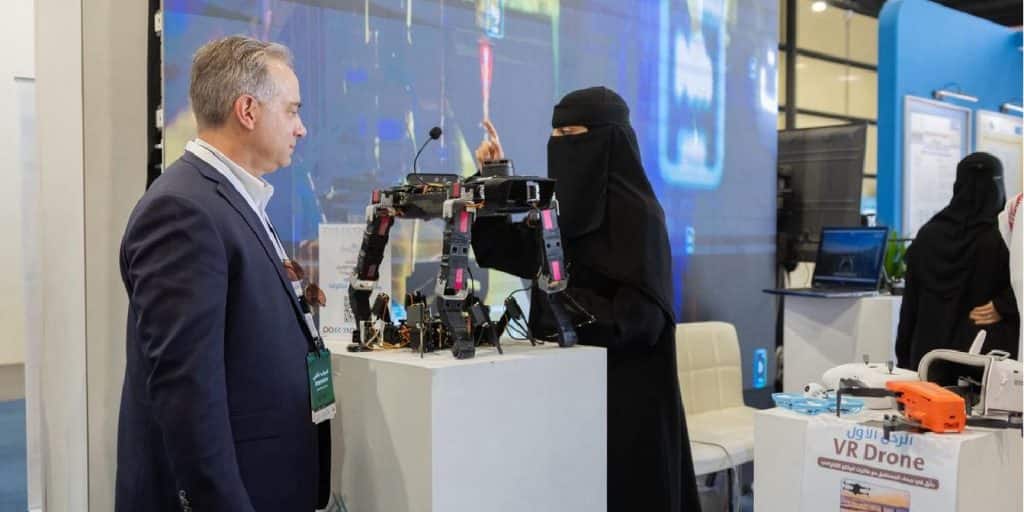 An academic discussion at the Qassim University pavilion at the Technology Exhibition to showcase drone projects.